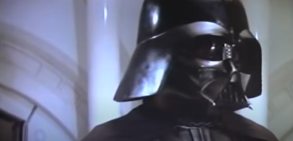 A character wearing a black mask from the movie Star Wars