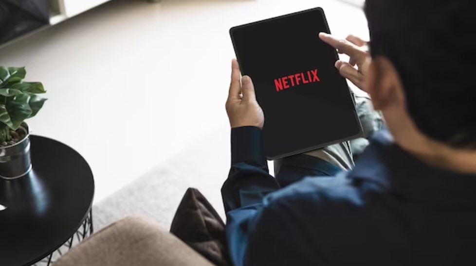a male using Netflix application to watch movies or TV series on stream