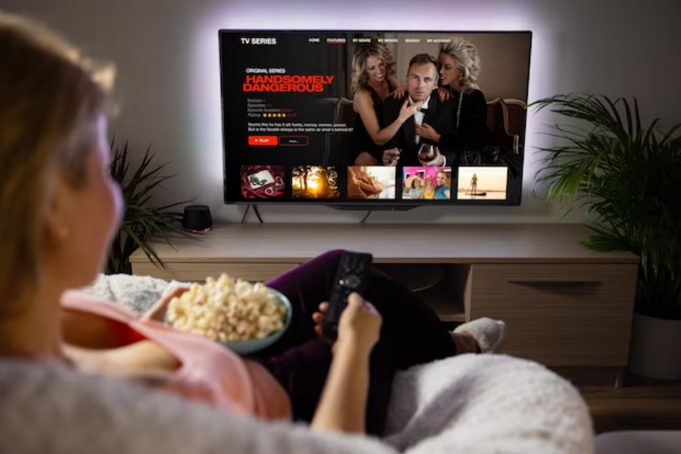 a woman watching TV series or movies via a streaming service at home
