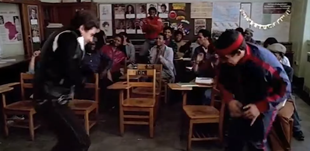 Two people having a dance showdown in a classroom