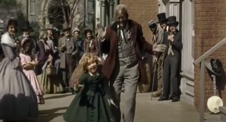 Happy African American man walking with a little girl on the street