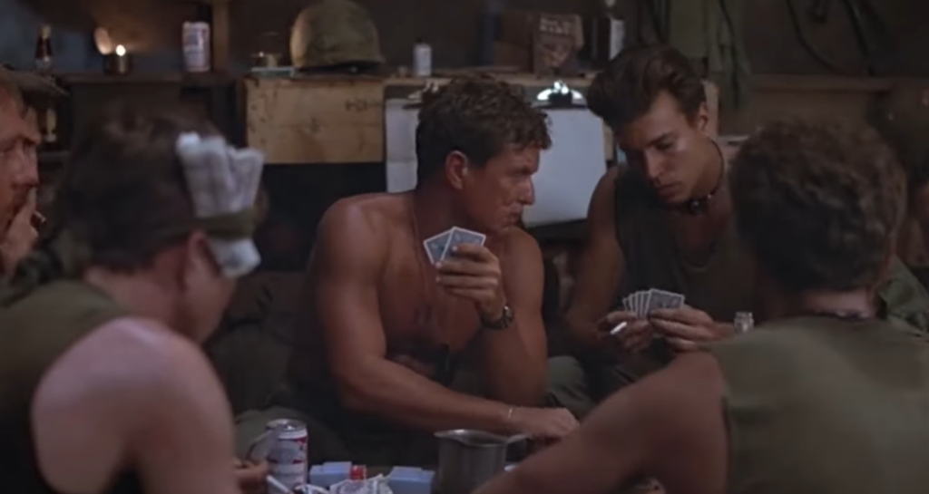 group of men sittings at the table and playing cards